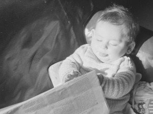 Your Author, at a slightly younger age, perusing The Times of London